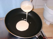 Pour a thin layer of dough on a hot greased pan.