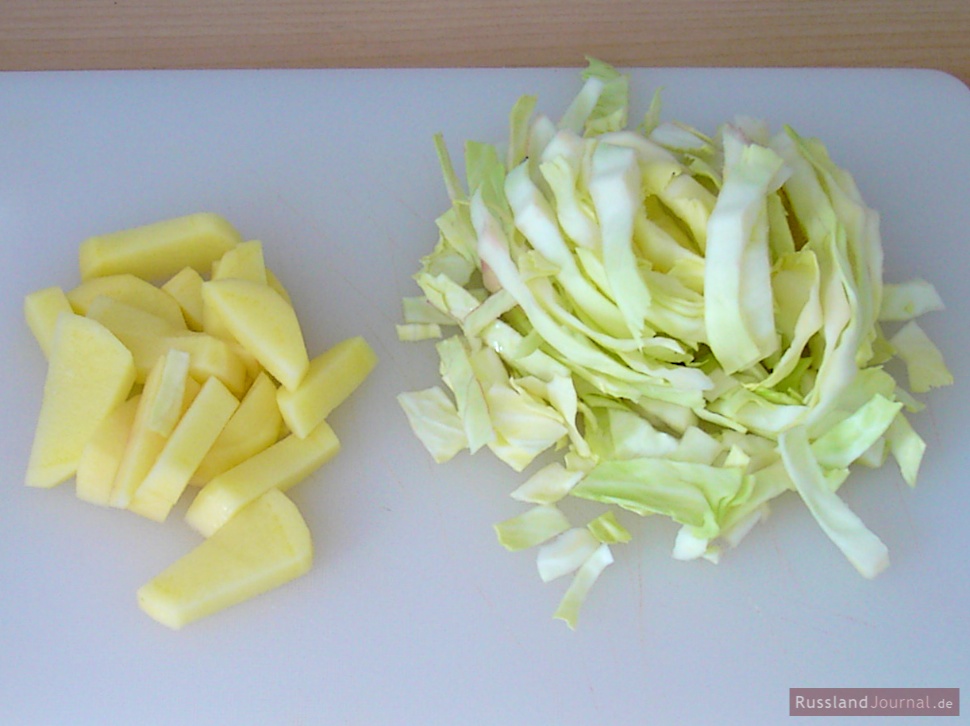 Cut potatoes into thick chips. Shred the cabbage.