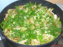 Finely chop green (spring) onions, parsley and garlic cloves. Add to the cabbage and simmer for about 5 minutes.