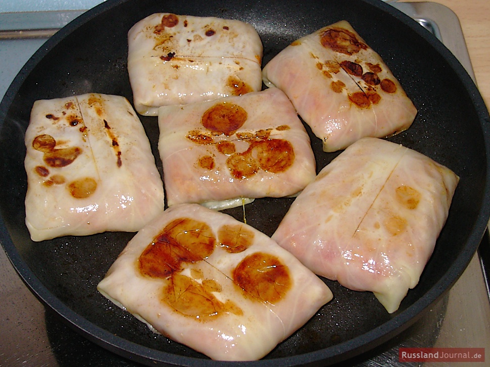 Heat oil or butter in a pan and fry golubtsi on both sides until golden brown.