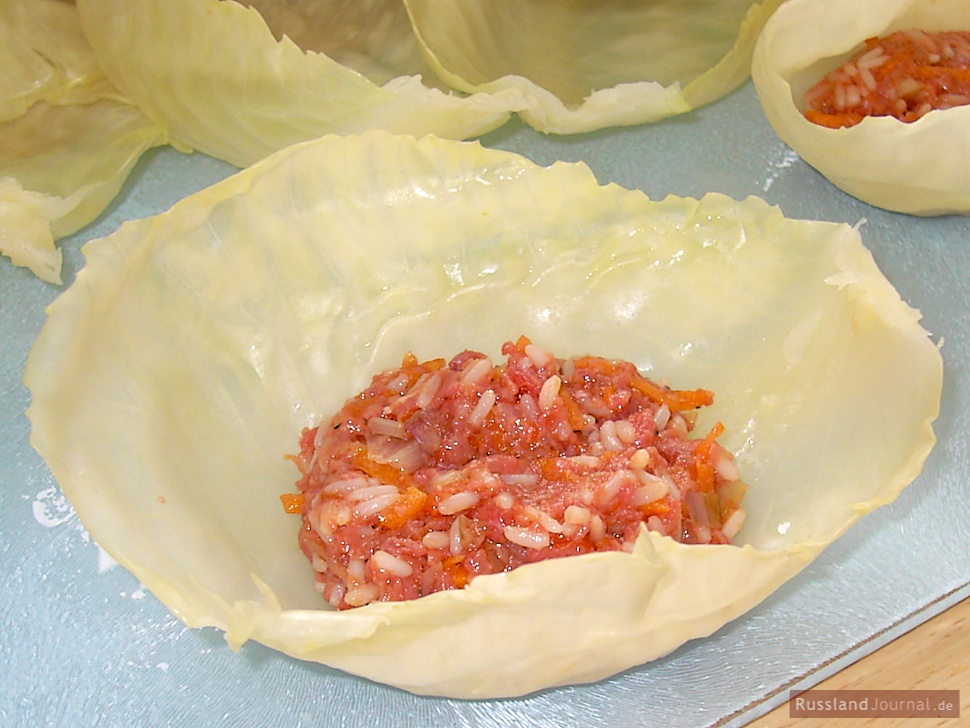 Put 1 tbsp of the filling on the inner side of each cabbage leaf.