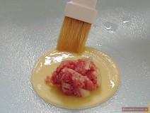 Fill each cut-out with one teaspoon of minced meat and brush the edges with egg white.