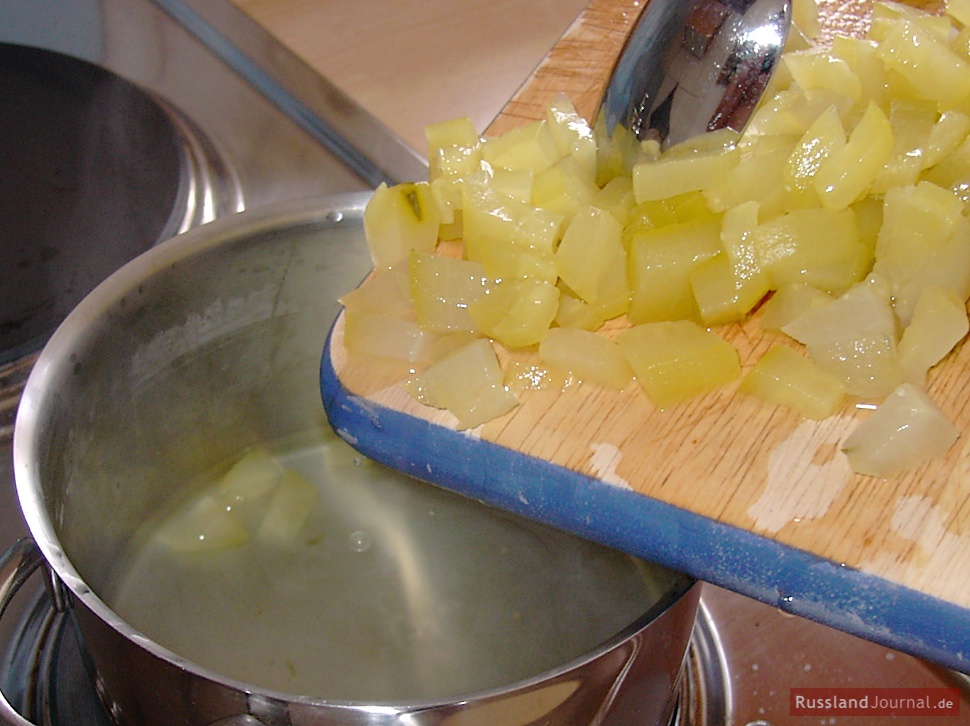 Cut peeled cucumbers into small pieces. Put them in the pan with the liquid and simmer for another 10 minutes.