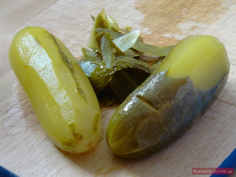 Peel pickled cucumbers.