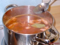 Boil the stock up, add stirred onions, cucumbers, meat, brine, peppercorns and the bay leaf and simmer for about 10 minutes.